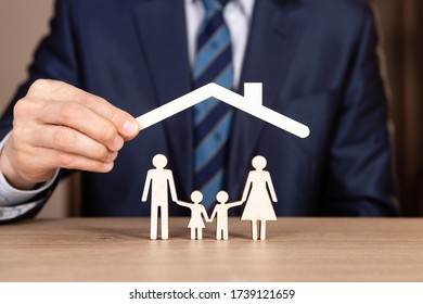 Concept of family insurance with hands protecting a family