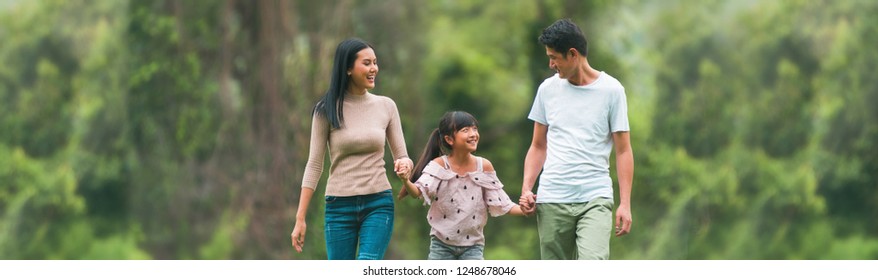 Concept Family Relaxation.Asian Family Playing In The Garden