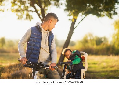 concept of father's day. loving caring dad walks in the park with his 2 year old son
