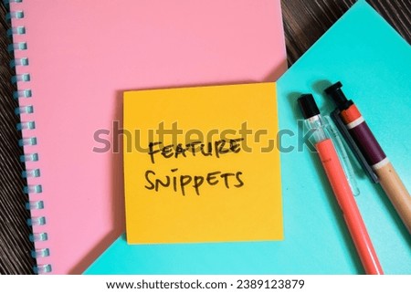 Concept of Feature Snippets write on sticky notes isolated on Wooden Table.