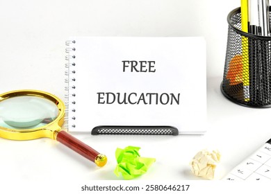 A concept featuring a notepad stating free education alongside a magnifying glass and colorful paper balls, symbolizing learning and growth.