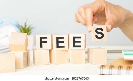 Concept Fees: Wooden cubes with the letters Fees on wooden background