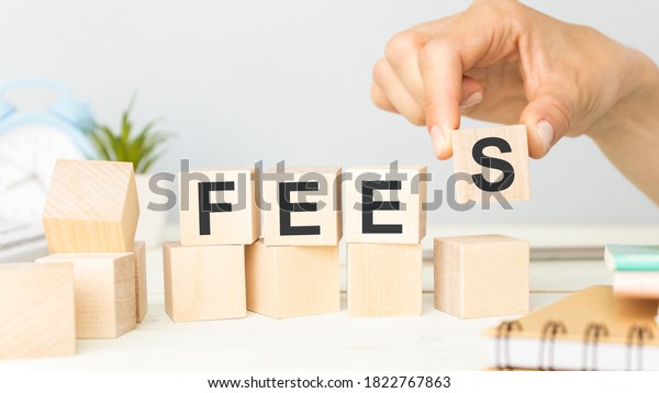 Concept Fees: Wooden cubes with the letters\
Fees on wooden\
background