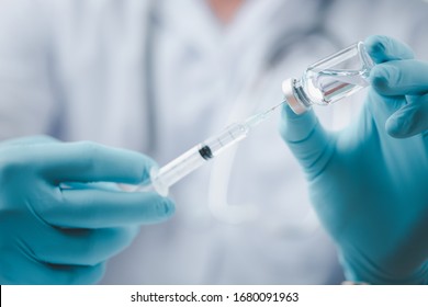 Concept fight against virus covid-19 corona virus, doctor or scientist in laboratory holding a syringe with liquid vaccines for children or older adults,Concept:diseases,medical care,science. - Shutterstock ID 1680091963