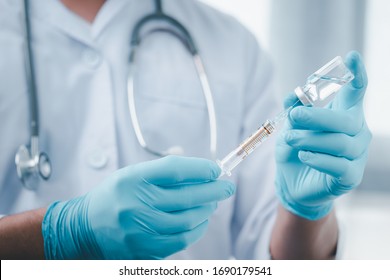 Concept fight against virus covid-19 corona virus, doctor or scientist in laboratory holding a syringe with liquid vaccines for children or older adults,Concept:diseases,medical care,science.