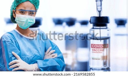 Concept fight against virus covid-19 corona virus, doctor with a blue coat and surgical mask with a bottle of COVID-19 vaccine adults, Concept: diseases, medical care, science.