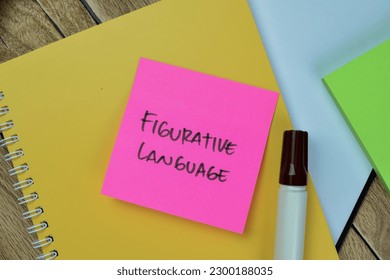 Concept of Figurative Language write on sticky notes isolated on Wooden Table.