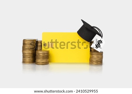 Concept of financial literacy and education. Bank card and graduation hat on gold coins. Economy of finances.
