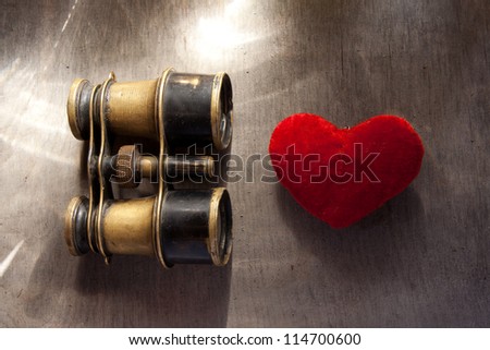 Concept Find Love. Old binoculars and heart.