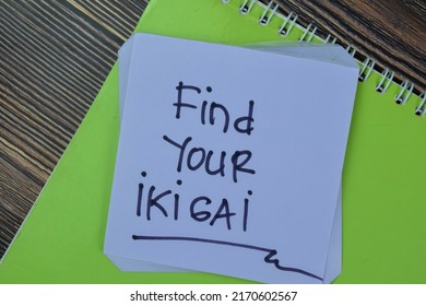 Concept of Find Your Ikigai write on sticky notes isolated on Wooden Table.