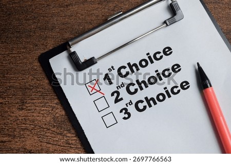 Concept of first choice opinion write on clipboard isolated on Wooden Table.