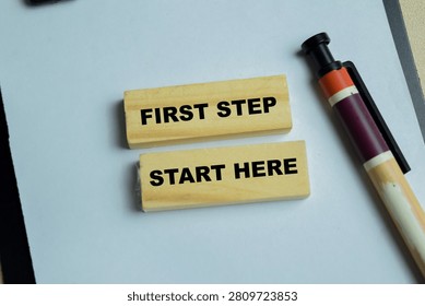 Concept of first step start here text on wooden blocks.