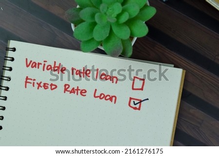 Concept of Fixed Rate Loan write on a sticky notes isolated on Wooden Table.