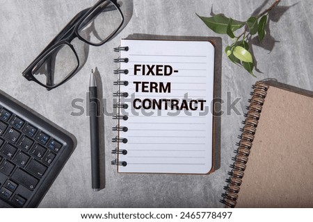 Concept of Fixed Term Contract write on sticky notes isolated on Wooden Table.