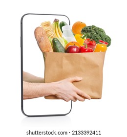 The Concept Of Food And Groceries Delivery. Hands With A Bag Of Food In A Smartphone