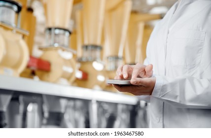 Concept Food Industry Banner. Factory Worker Inspecting Production Line Tanker In Of Flour Mill With Computer Tablet.