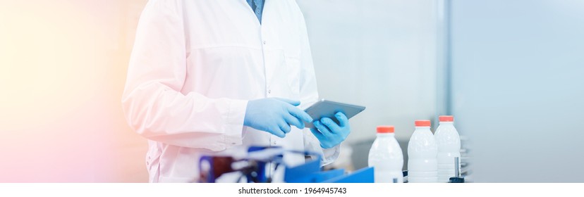 Concept Food Industry Banner. Worker Inspecting Production Line Bottle Milk Dairy Factory With Computer Tablet.