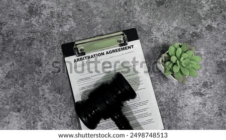 Concept form of Arbitration Agreement write on paperwork isolated on wooden background.