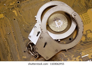 Concept Fraud With Crypto Currency. Fraud And Deception Of Electronic Criminals And Hackers. Coin Bitcoin And Police Handcuffs Lie On A Yellow Motherboard Computer Board.