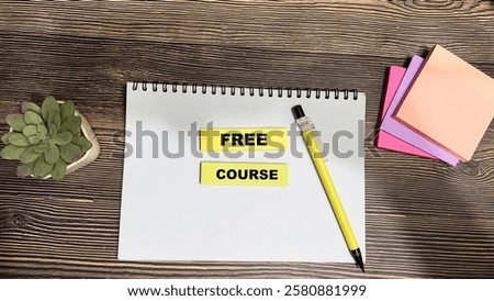 Concept of Free Course write on sticky notes isolated on Wooden Table.