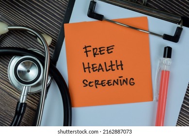 Concept Of Free Health Screening Write On Sticky Notes Isolated On Wooden Table.