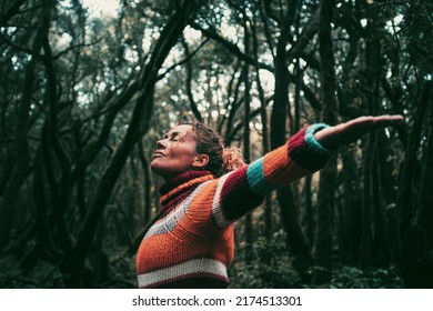 Concept of freedom and protection of forest in earth's day. Standing woman with closed eyes enjoy feeling with forest and trees around. Mindufulness exercise female adult. Positive moment with nature - Shutterstock ID 2174513301
