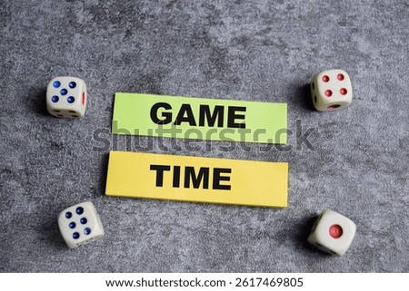 Concept of Game time write on sticky notes isolated on Wooden Table.