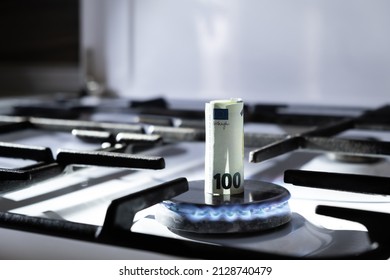 Concept Of Gas Crisis. 100 Euro Bank Note Is Burning On Kitchen Stove. Cash Money. High Prices Of Natural Resources. Blue Flame. Utility Debt. Number Hundred. Energy War. Saving Home Budget. Finance