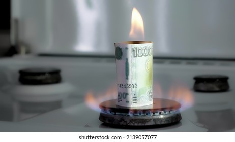 Concept Of Gas Crisis. 1000 Russian Rubles Bill Is Burning On A Kitchen Stove Burner. Cash Money. High Prices Of Natural Resources. Fire Flame. Utility Debt. Energy War. Saving Home Budget. Finance.