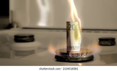 Concept Of Gas Crisis. 2000 Russian Rubles Bill Is Burning On A Kitchen Stove Burner. Cash Money. High Prices Of Natural Resources. Fire Flame. Utility Debt. Energy War. Saving Home Budget. Finance.