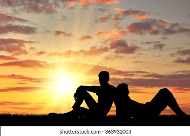 Concept of gay people. Silhouette of two gay vacationers at sunset