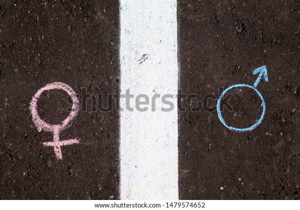 The concept of gender equality.\
Figure male and female symbol on the asphalt with\
chalk.