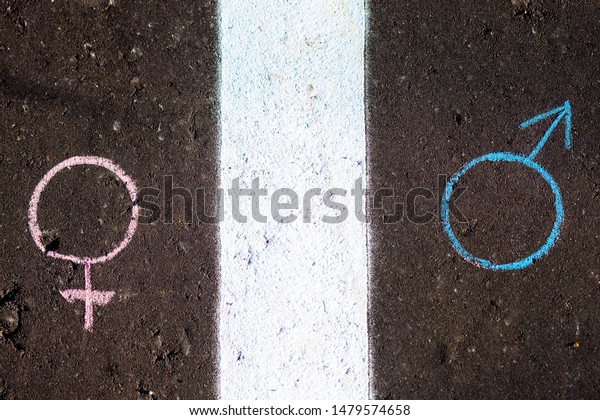 The concept of gender equality.\
Figure male and female symbol on the asphalt with\
chalk.