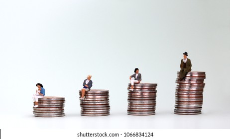 The concept of gender inequality. The woman sitting on a coin holding a baby. - Shutterstock ID 1066834124