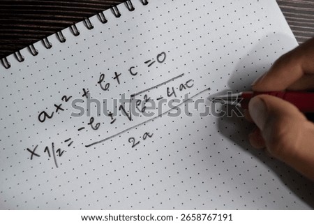 Concept of general quadratic equation write on book isolated on Wooden Table.