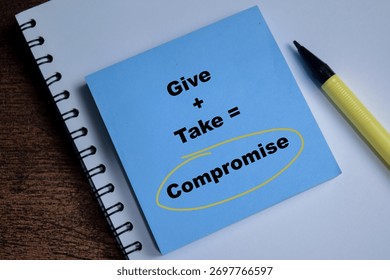 Concept of give and take compromise write on sticky notes isolated on Wooden Table.