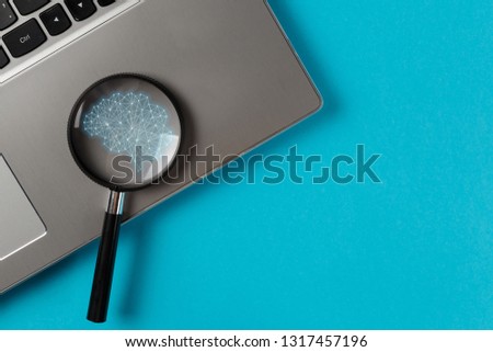 The concept of global information retrieval using neural networks. Artificial intelligence, machine and deep learning, neural networks, modern technologies. Magnifying glass on the work desk