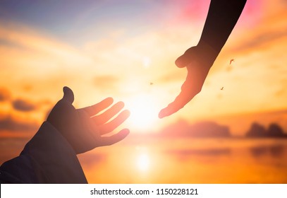 The concept of God's salvation:silhouette of helping hand concept and international day of peace - Shutterstock ID 1150228121