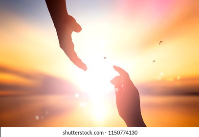 The concept of God's salvation:silhouette of helping hand concept and international day of peace - Shutterstock ID 1150774130