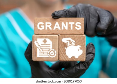 Concept Of Grant. Grants For Medical Innovation, Research, Education. Doctor Holding Wooden Blocks With Grants Concept.