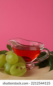 Concept Of Grape Vinegar On Pink Background