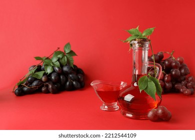 Concept Of Grape Vinegar On Red Background