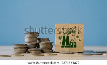 Concept of green Co2 Tax.Carbon tax, environmental and social responsibility business concept. Taxation for nature pollution.Wooden cubes with CO2 TAX word and stack coin.