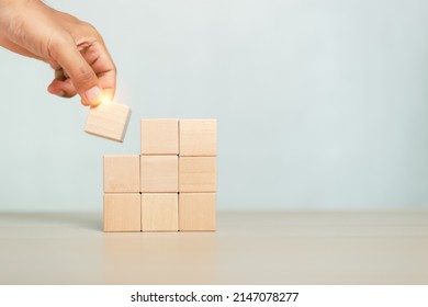 concept of grow success. hand holding and stacking wooden block cube step of business growth success. - Shutterstock ID 2147078277