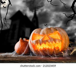 Concept of halloween pumpkin on wooden planks. Blur scary castle on background - Powered by Shutterstock