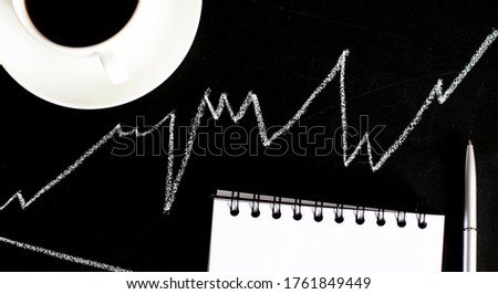 concept hand drawn on black blackboard with coins ,notebook and cup of coffee