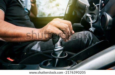 Concept of hand grabbing the gear lever of a car with copy space, Close-up of driver hand on the gear lever of a car, close-up of hands accelerating on the gear lever