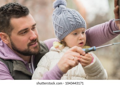 The Concept Of A Happy And Interesting Childhood. Father And Child Are Having Fun. Father And Daughter Make A Bird Feeder.