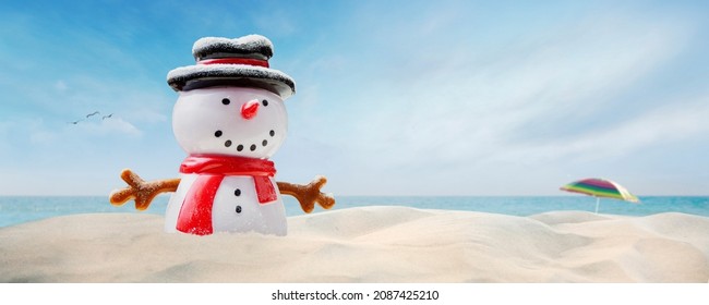 Concept - Happy Snowman On The Beach On Sunny Christmas Day Afternoon