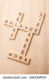 concept of harmony and balance between work, life and relax by  wood letters block   crossword on wooden background